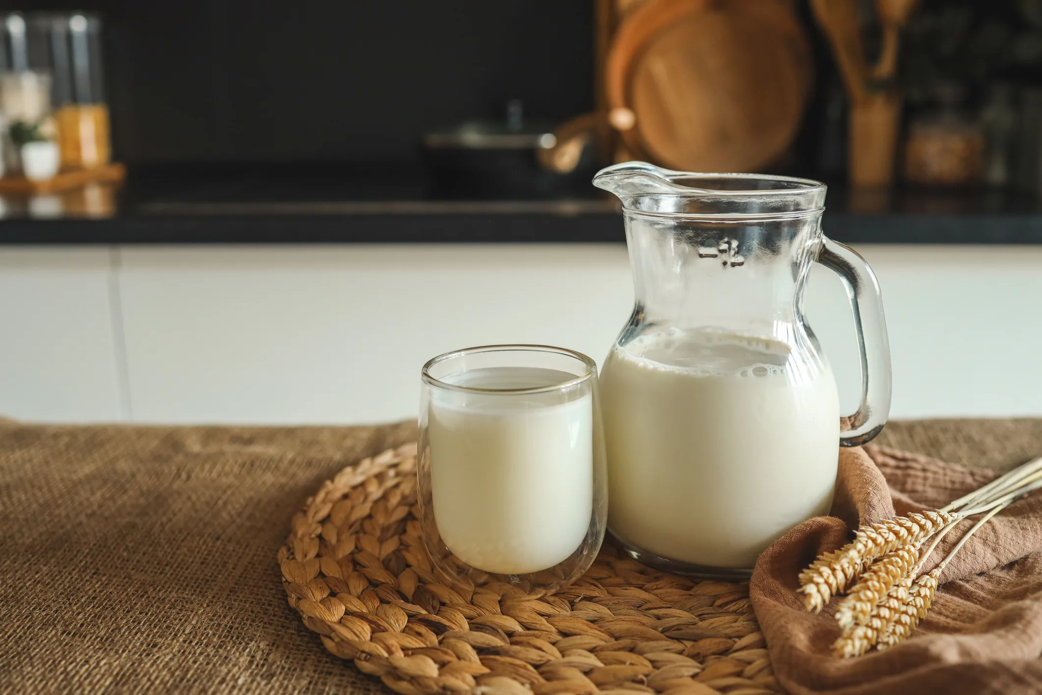 Fresh natural milk in a glass and jug at home Fresh natural milk in a glass and jug at home.
